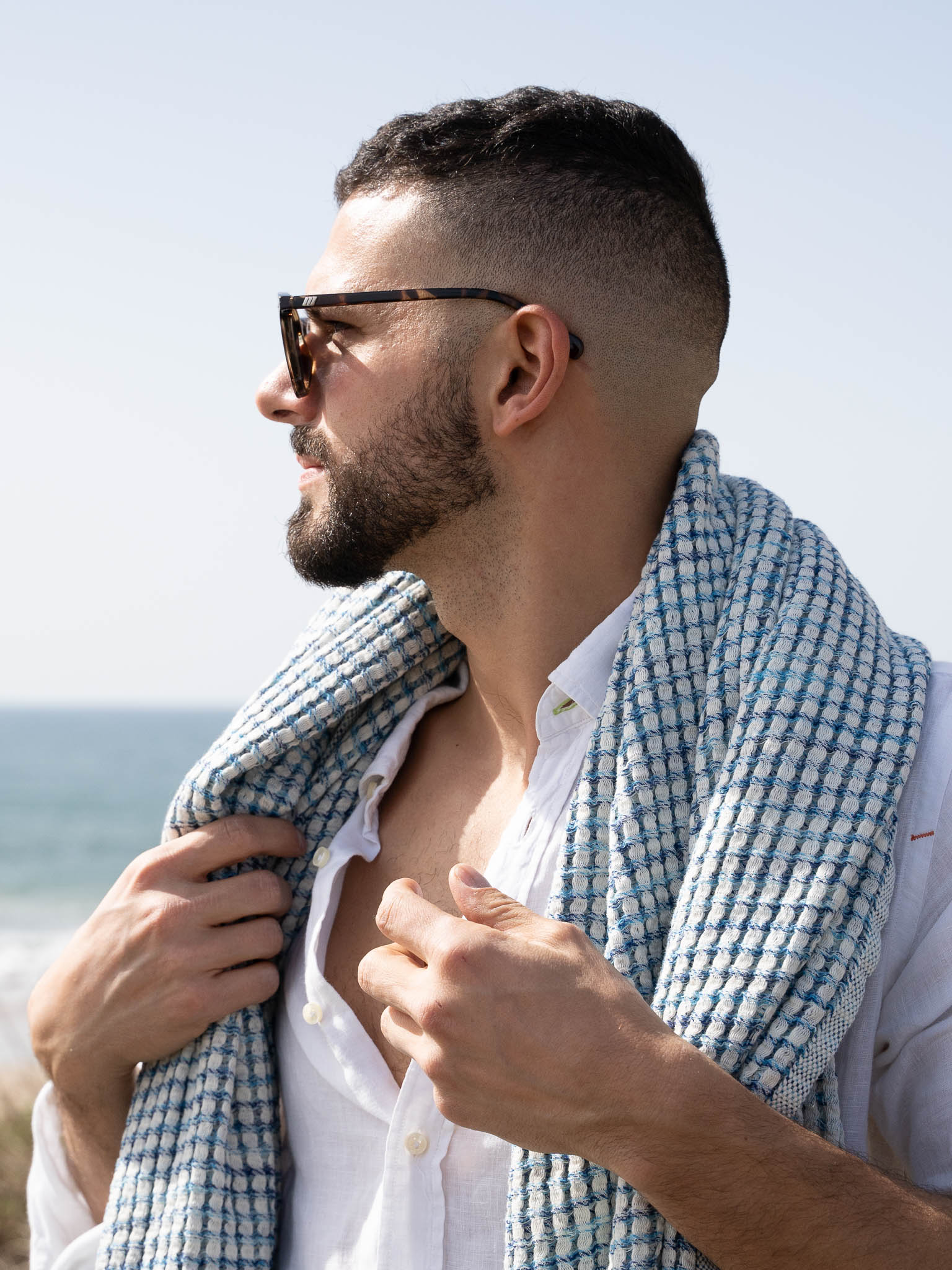 Man with blue patterned honeycomb beach towel