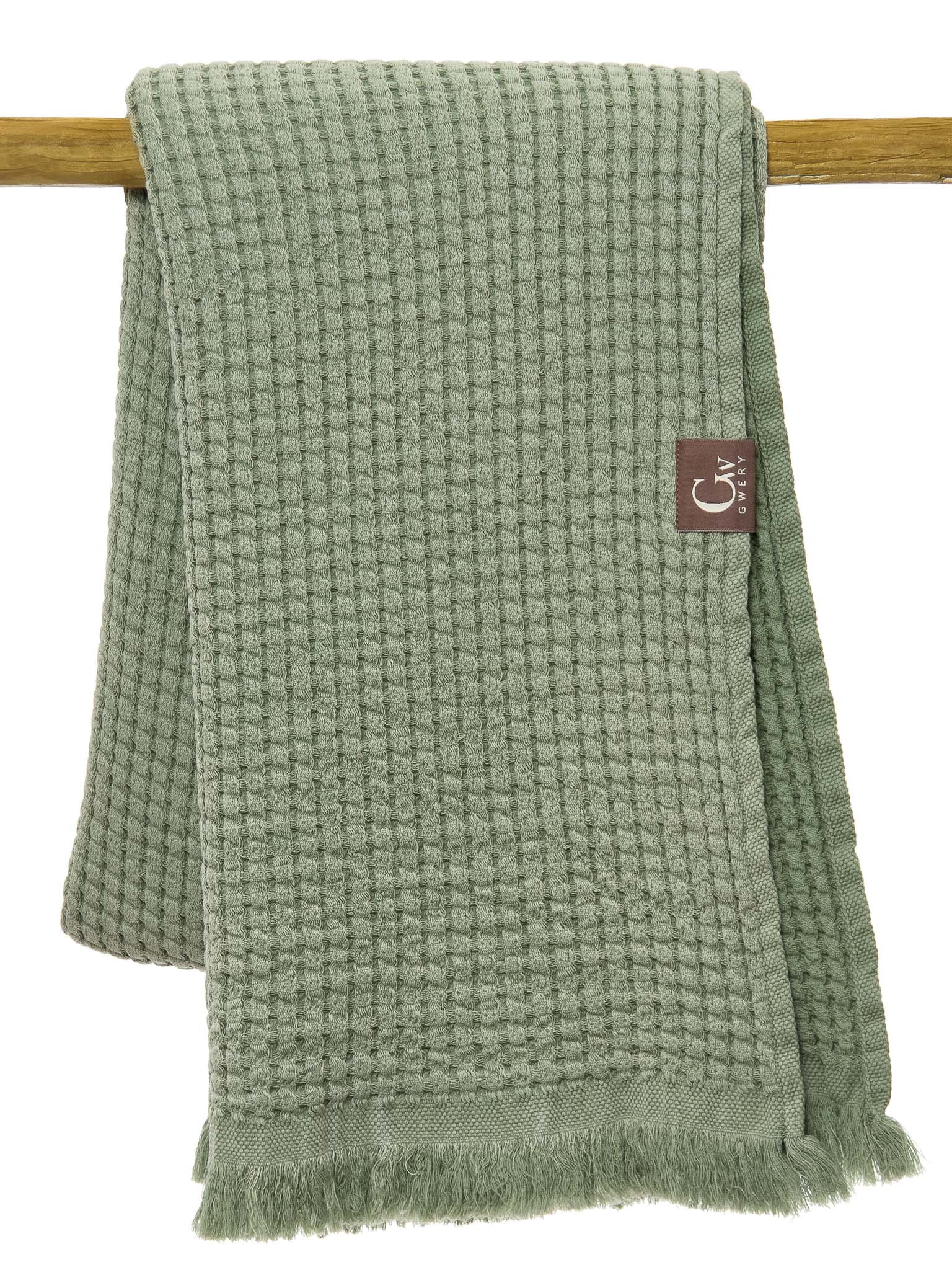 Green double sided, honeycomb beach towel folded