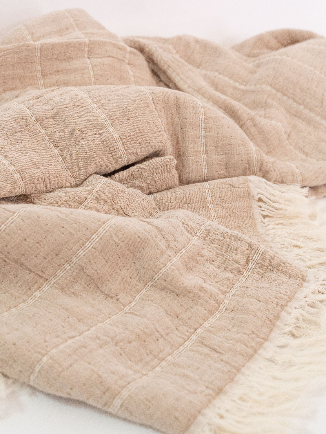 brown horizontal striped organic blanket close up