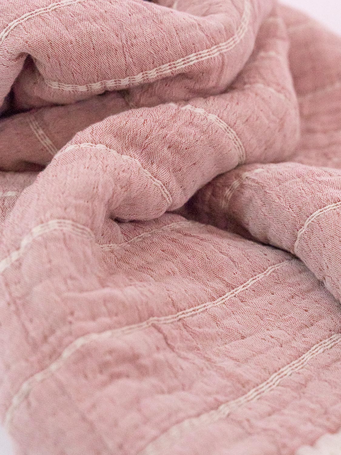 pink horizontal striped organic blanket close up