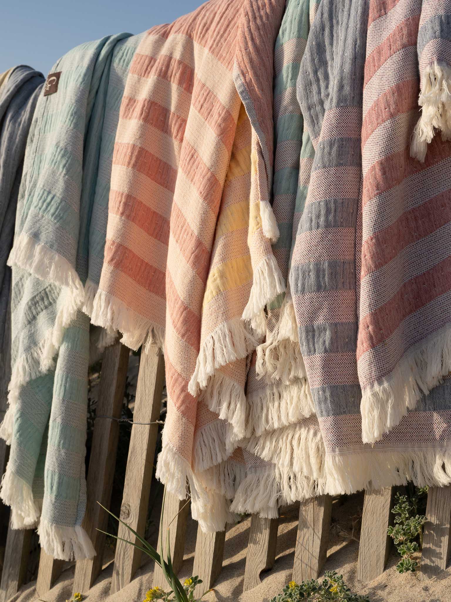 Gwery beach towels hanged on a beach