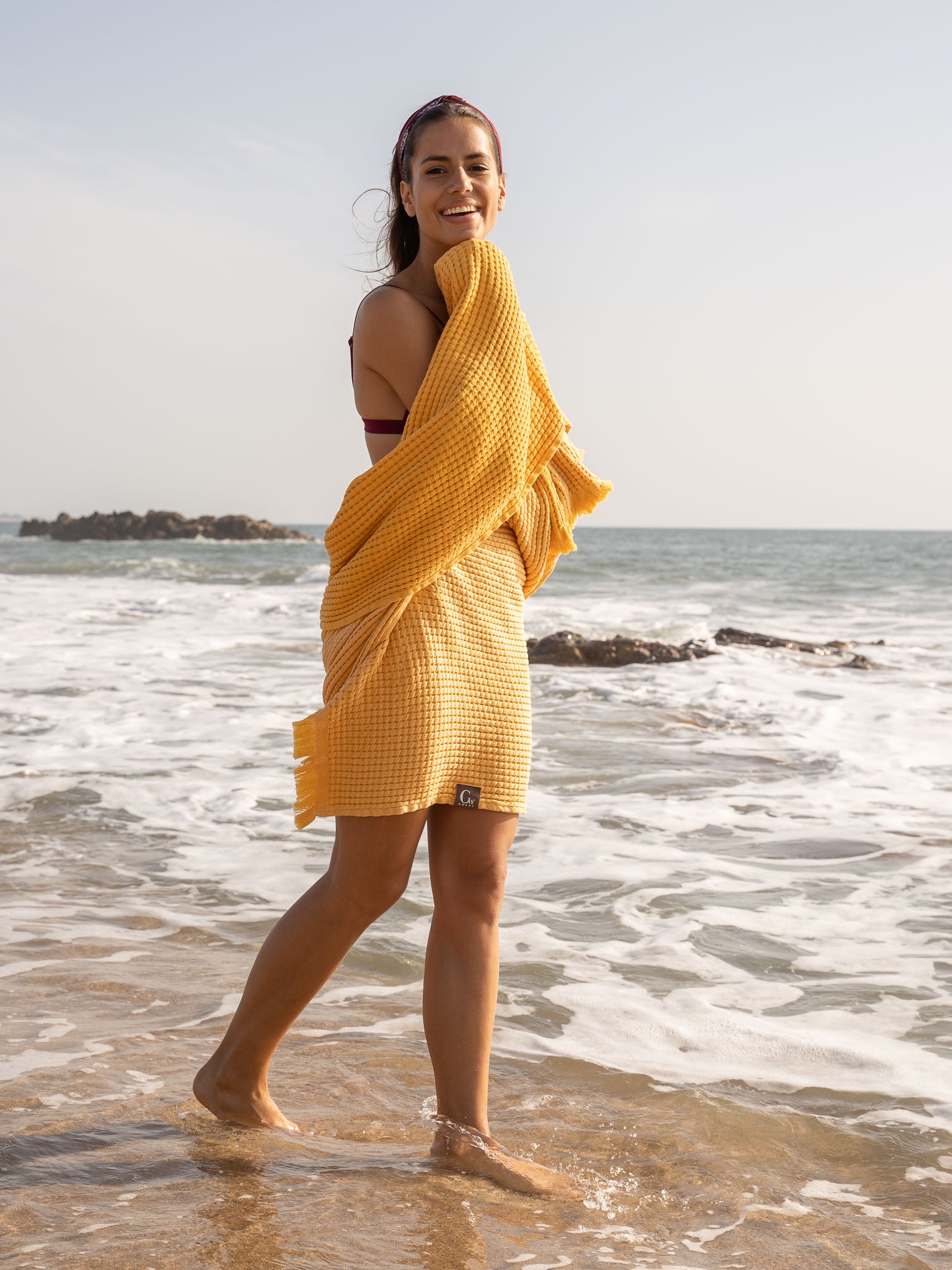 Girl near the sea with Yellow double sided honeycomb beach towel