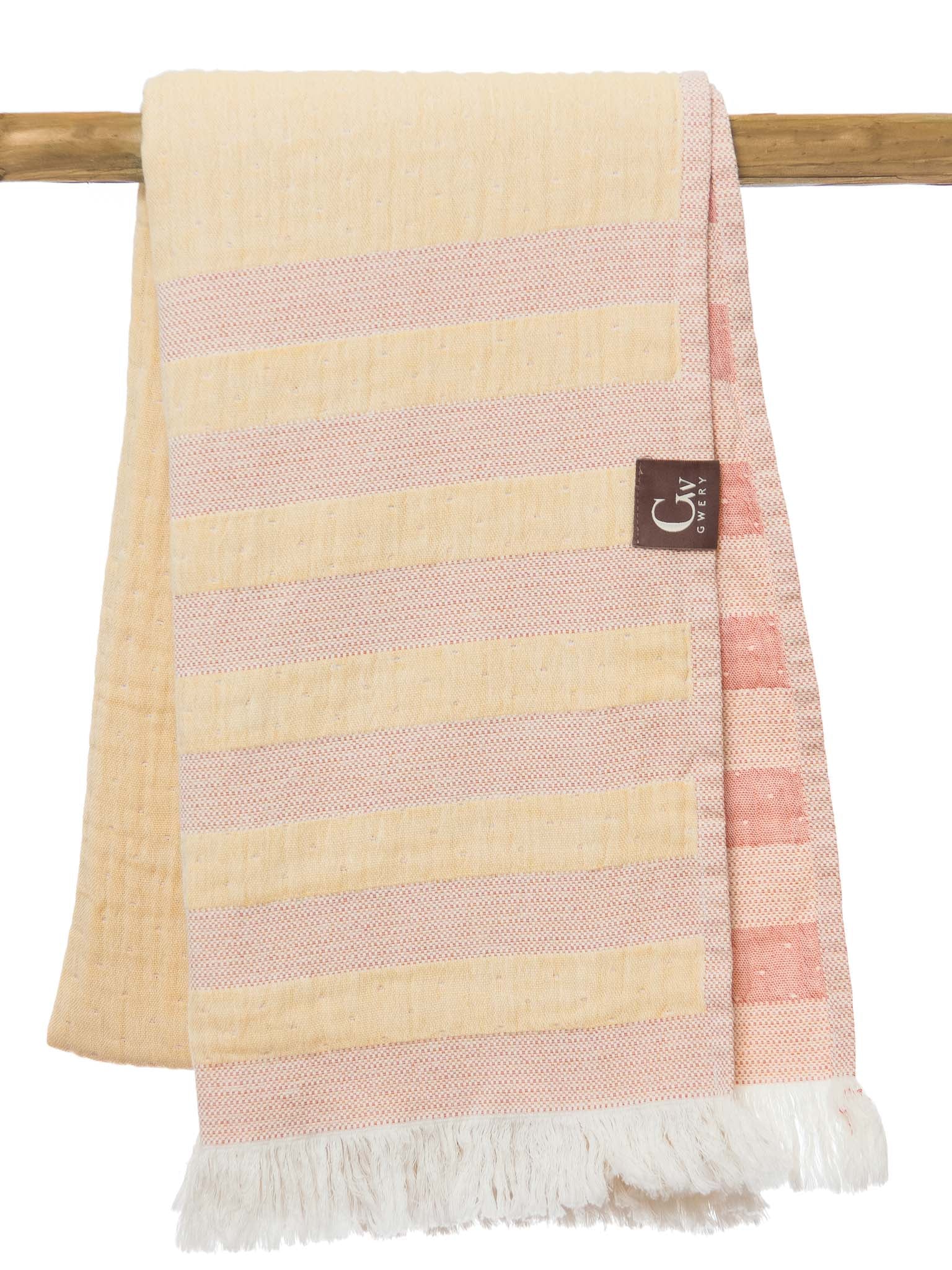 Yellow and orange striped beach towel folded