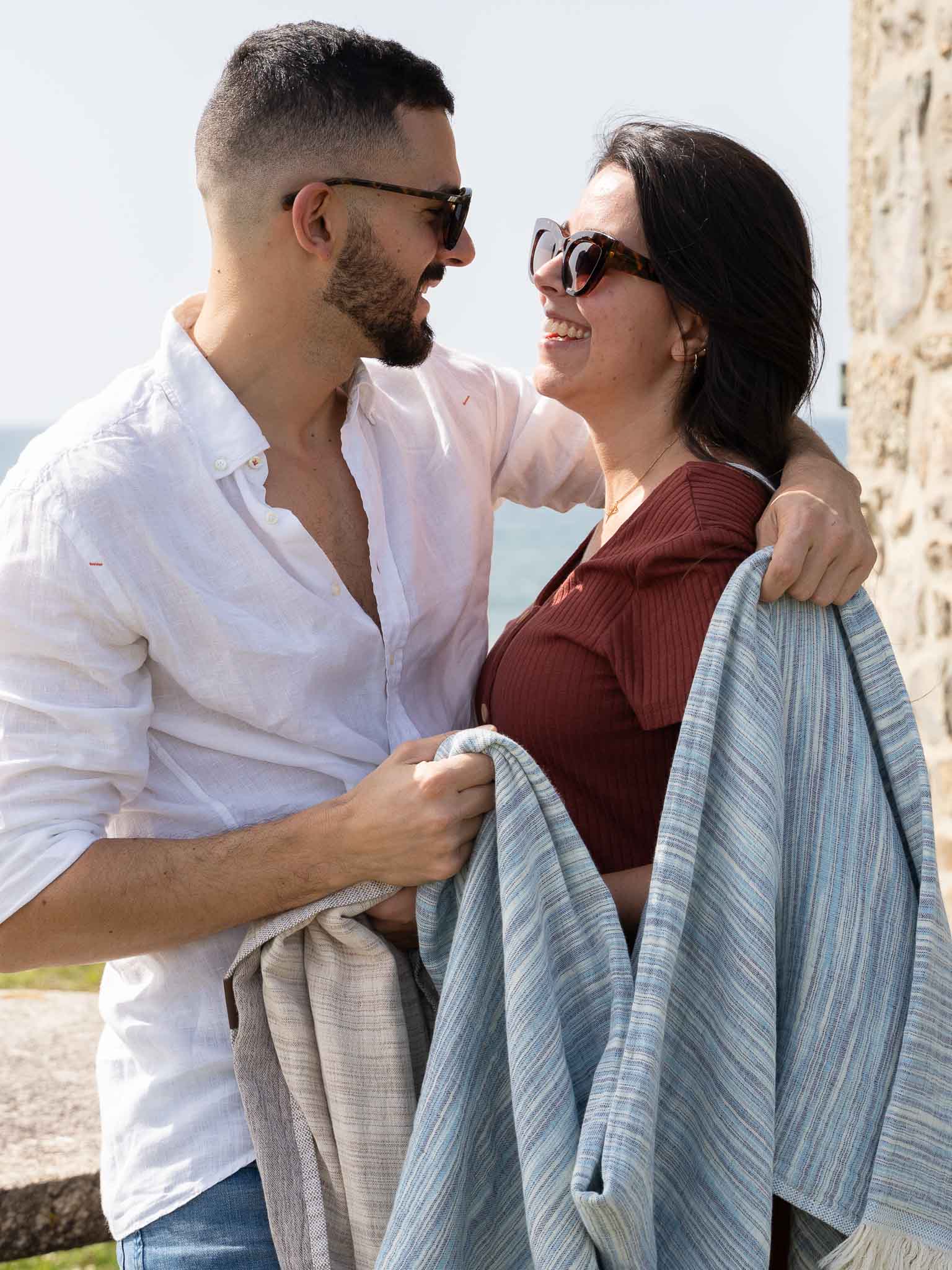 couple with blue patterned double sided beach towel