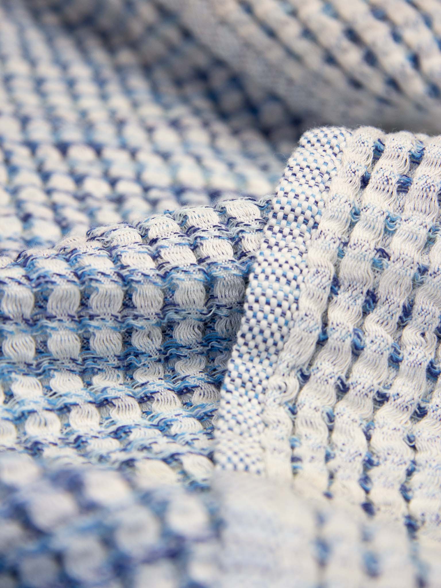 Blue patterned, double sided, honeycomb beach towel close up