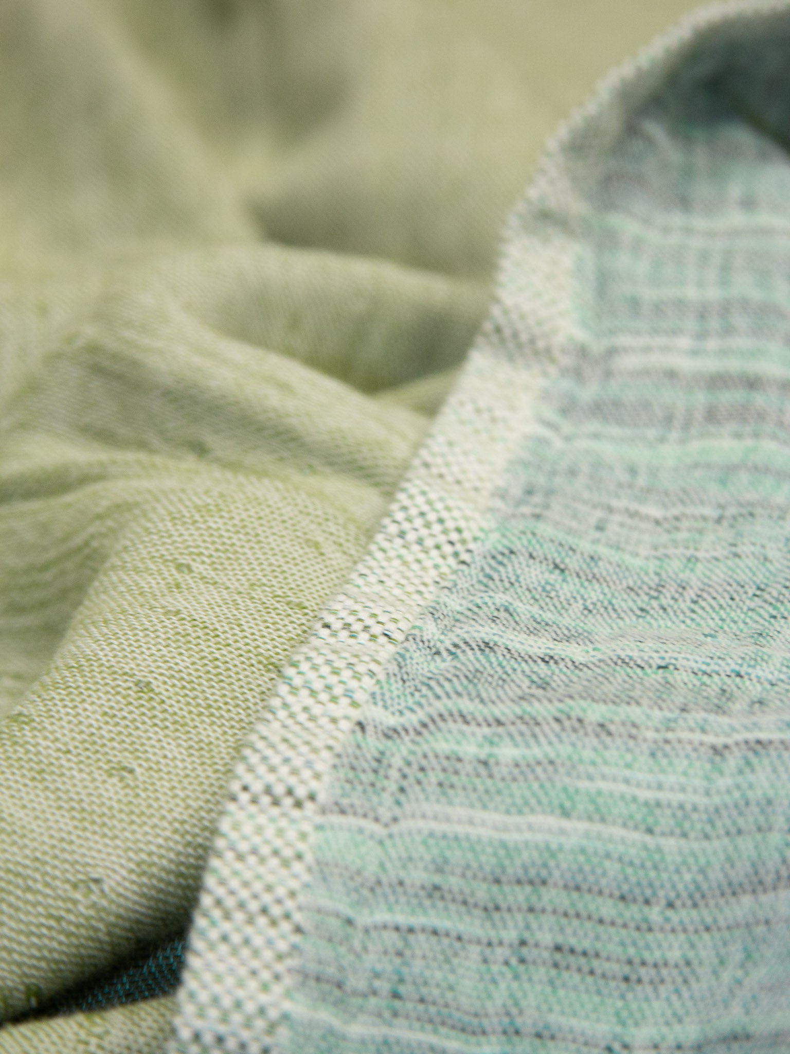 Green patterned, double sided, beach towel close up
