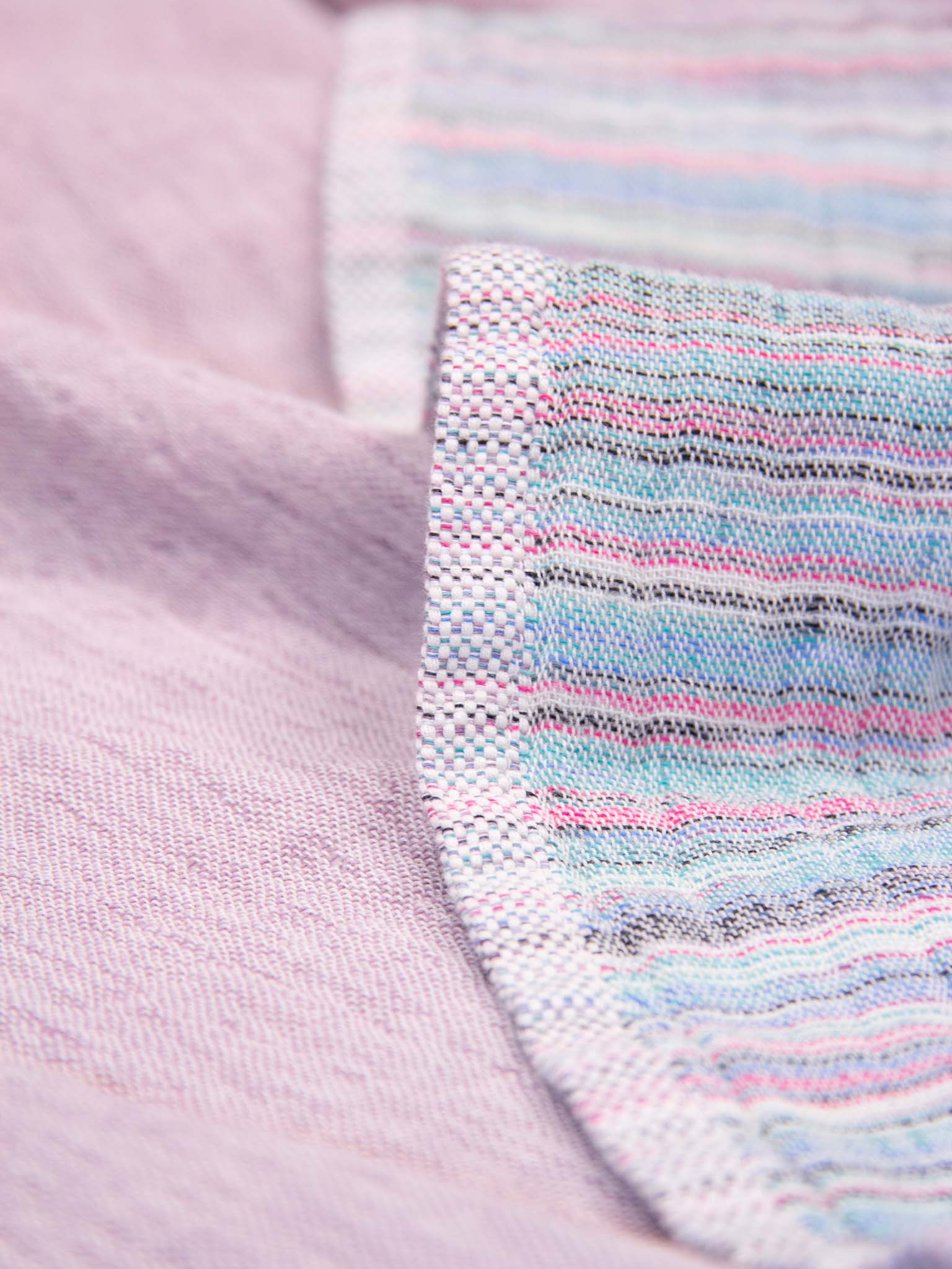 Purple patterned, double sided, beach towel close up