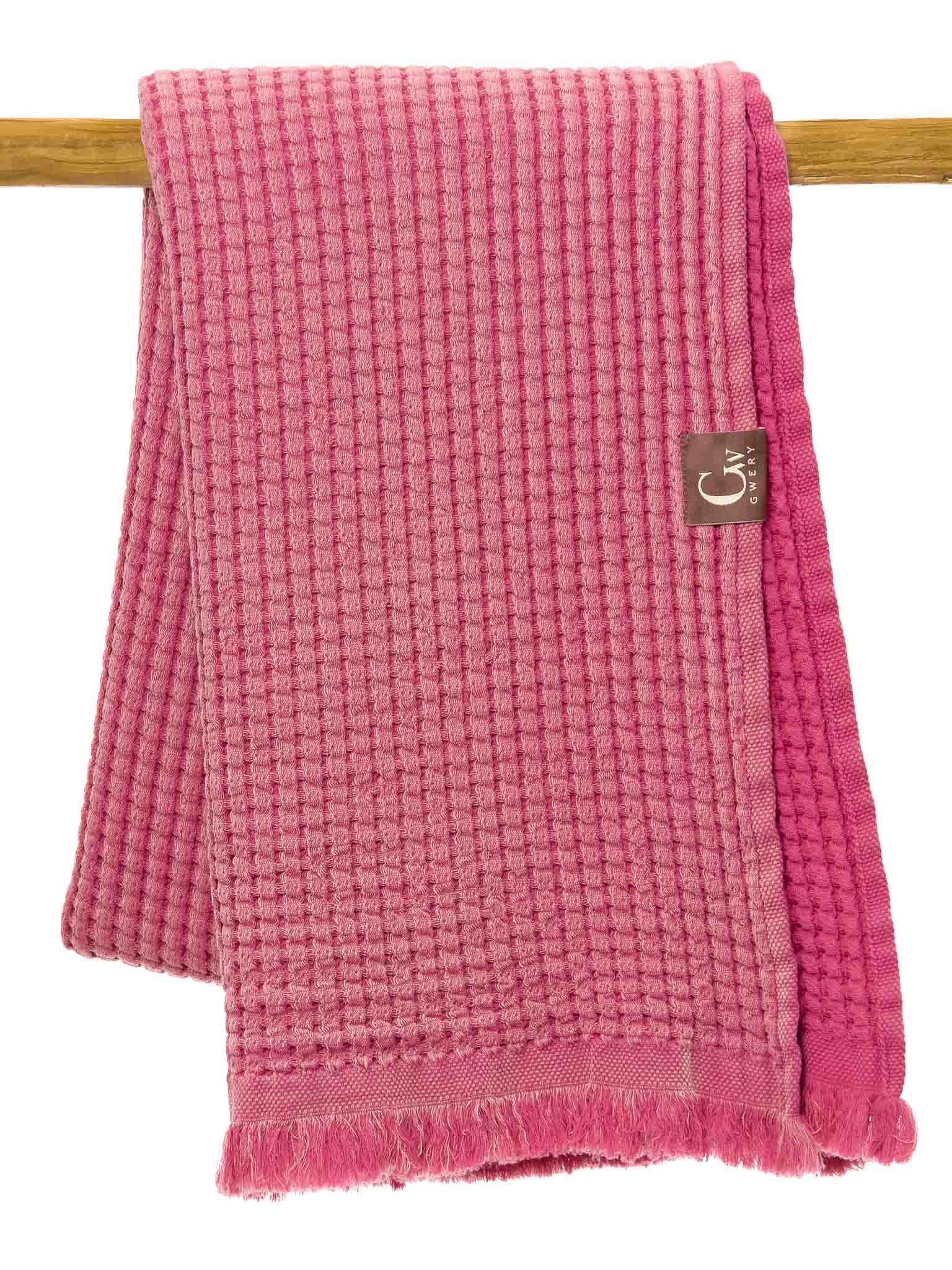 Pink double sided, honeycomb beach towel folded