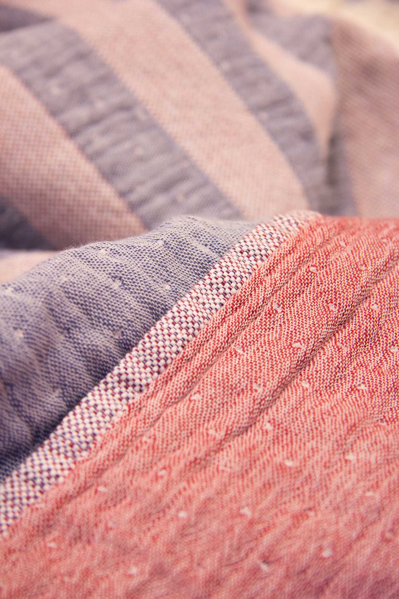 Red and blue double sided striped beach towel close up