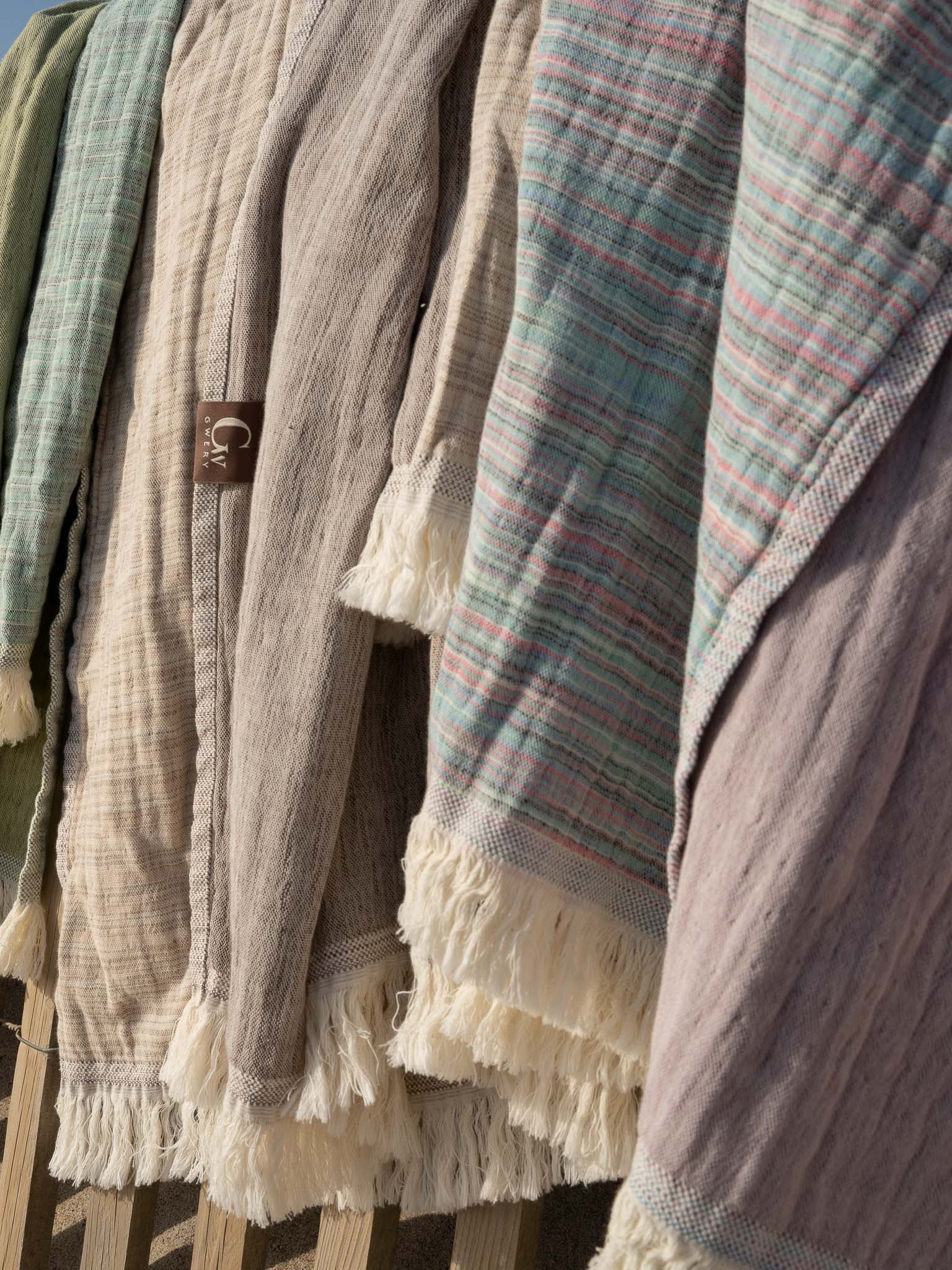 Gwery beach towels hanged on a beach