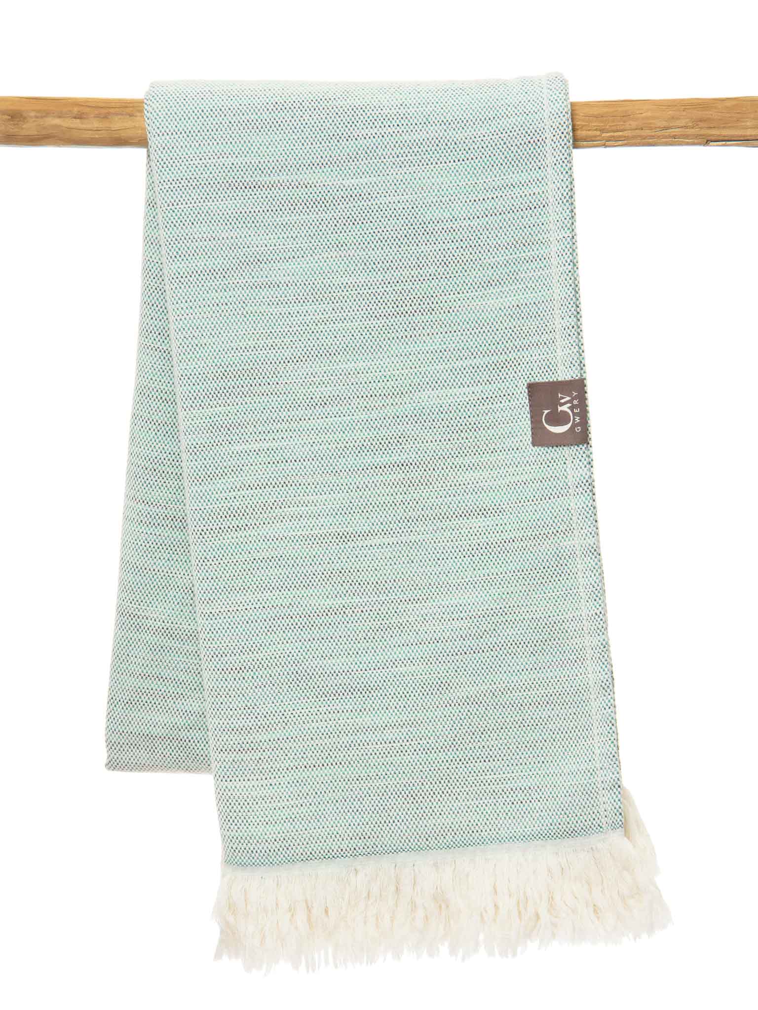 Green patterned lightweight beach towel folded