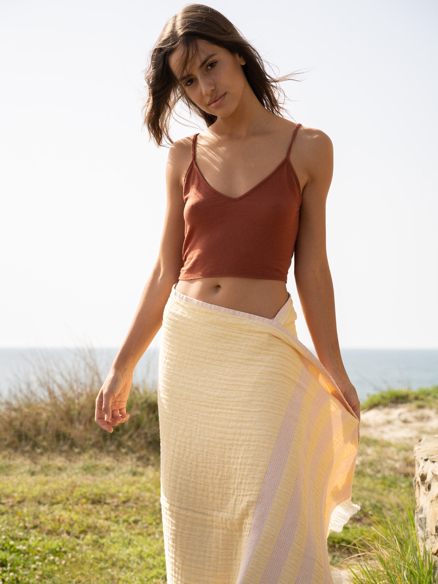 Girl with Yellow and orange striped beach towel